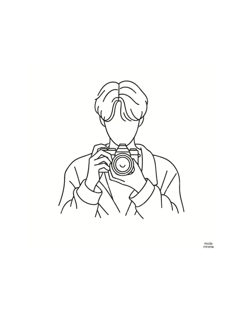 In Focus: a faceless figure holds a camera up to the face in a simple bust-length line drawing.
